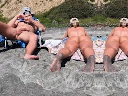 Middle aged couple relaxing on beach jpg x Nude beach couples