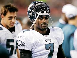 Vick standing with his helmet off