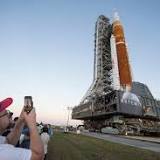 Symbolic baton rides with NASA Artemis I rocket on rollout for launch